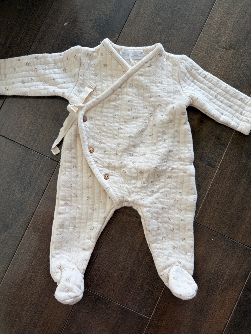 Zara Cream Footed Baby One-Piece with Light Floral Accents